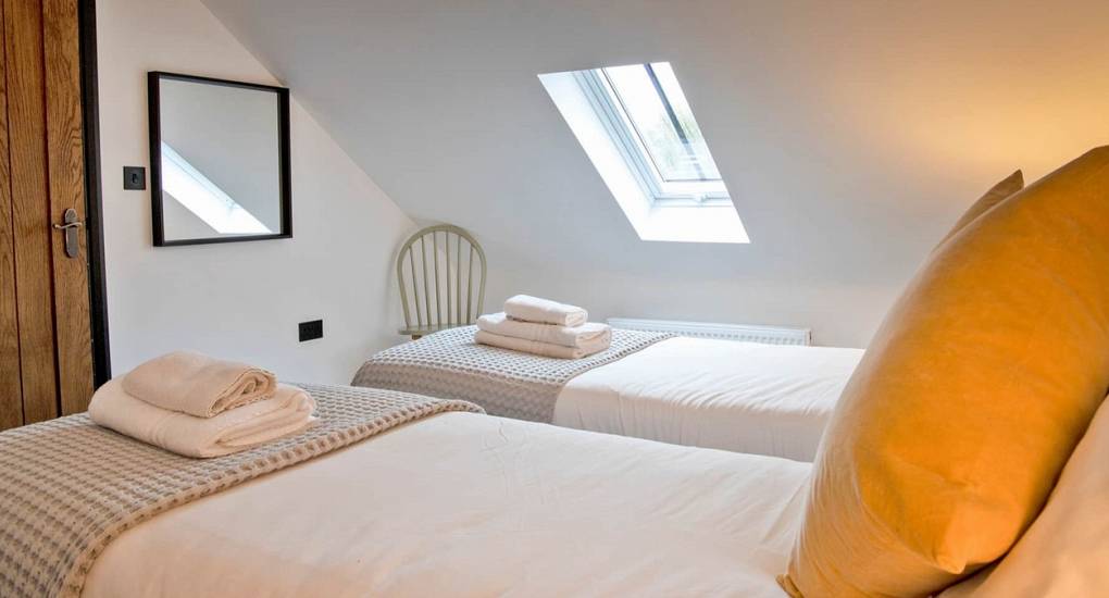 Bright twin bedroom at Lathkill Escape, a flexible luxury hen party accommodation in the Peak District.