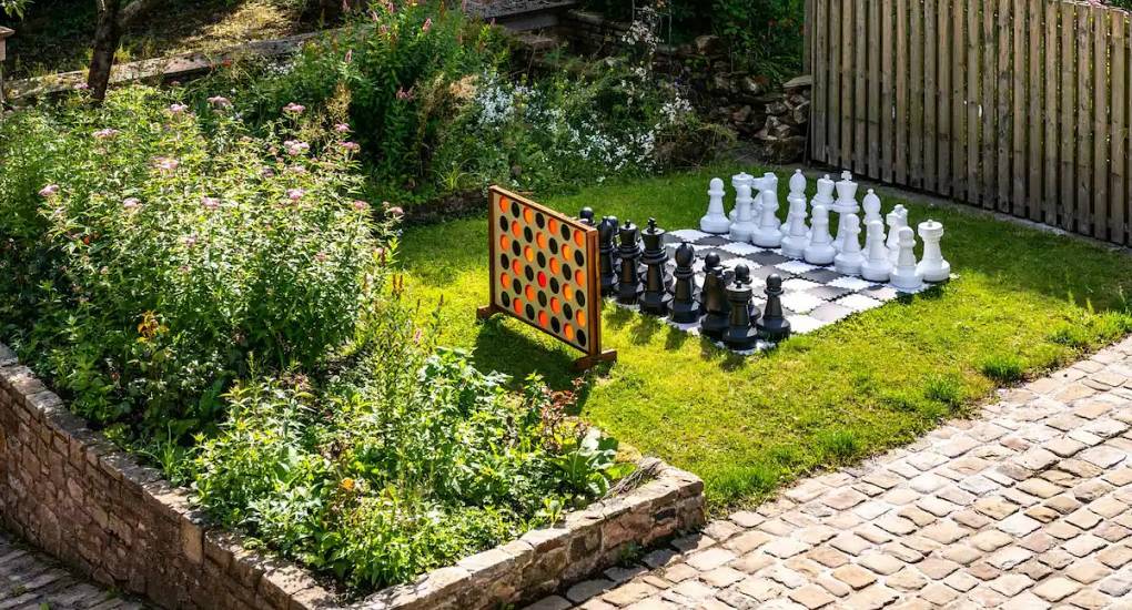 Small patch of grass in the courtyard with giant chess and connect 4