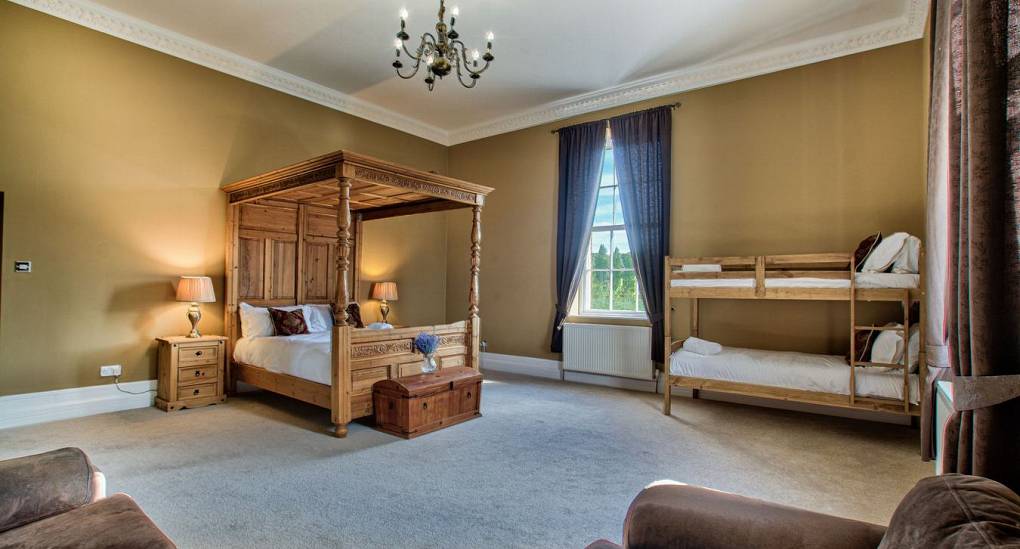 Tall ceiling in bedroom with multi beds