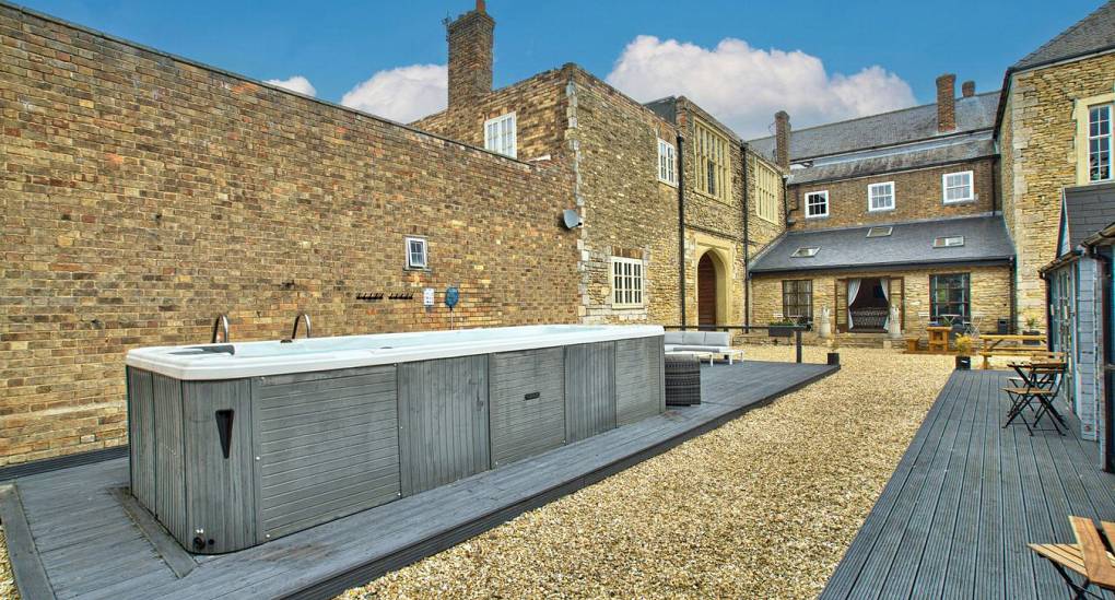 Large hot tub in courtyard garden