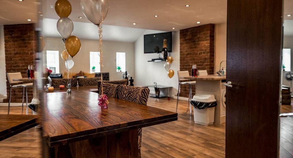 Spacious open plan dining room with zebra print chairs and party balloons at Party Gaff in central Liverpool.