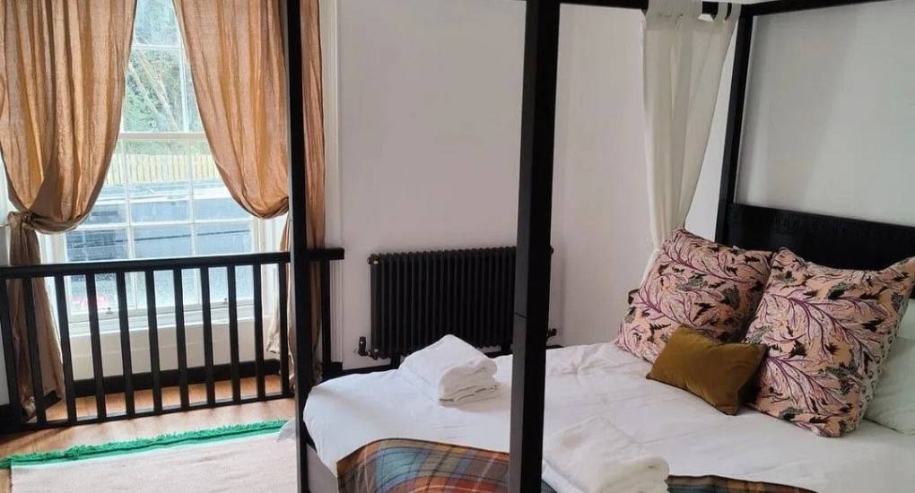 Bright and airy bedroom at Lux Life Edinburgh with ornate cornicing and comfortable beds, ideal for high-end hen party accommodation near the Royal Mile.