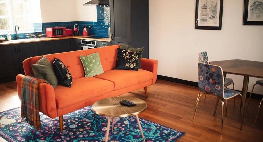 Stylish secondary social lounge at Lux Life Edinburgh with plush seating and modern decor, perfect for large group stag do accommodation in a central Edinburgh townhouse.