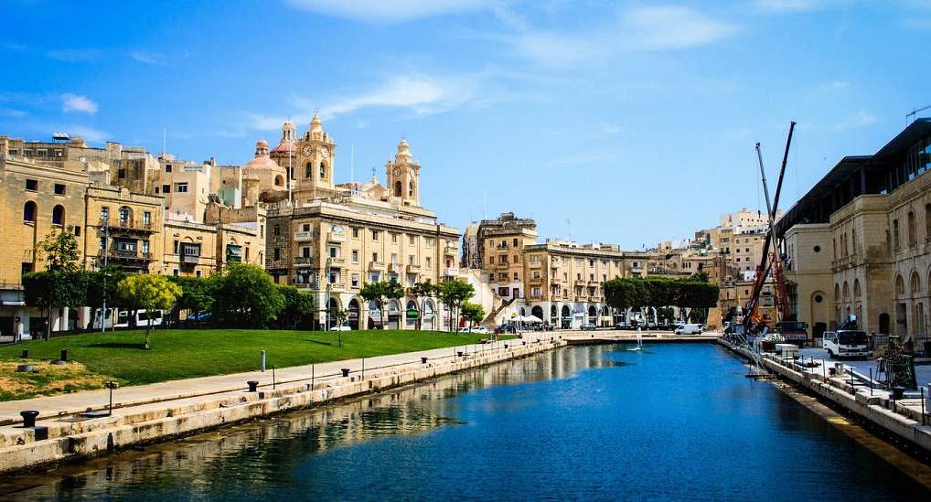 Cospicua Dock 1 canal promenade and historic Maltese limestone buildings, scenic waterfront for a Malta stag do.