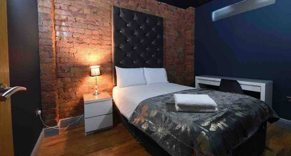 Rustic style bedroom with double bed in the Manchester party house, The White House