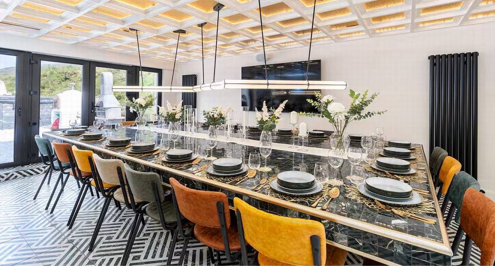 Alternate view of the spacious dining room designed to seat twenty-one guests for a hen weekend