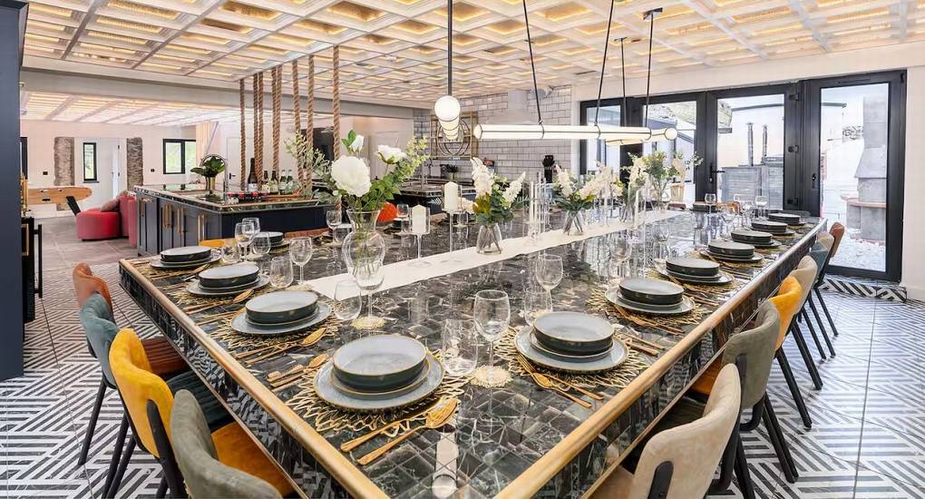 Large dining table set up for a group dinner inside the Manor on the Mountain Lake District party house