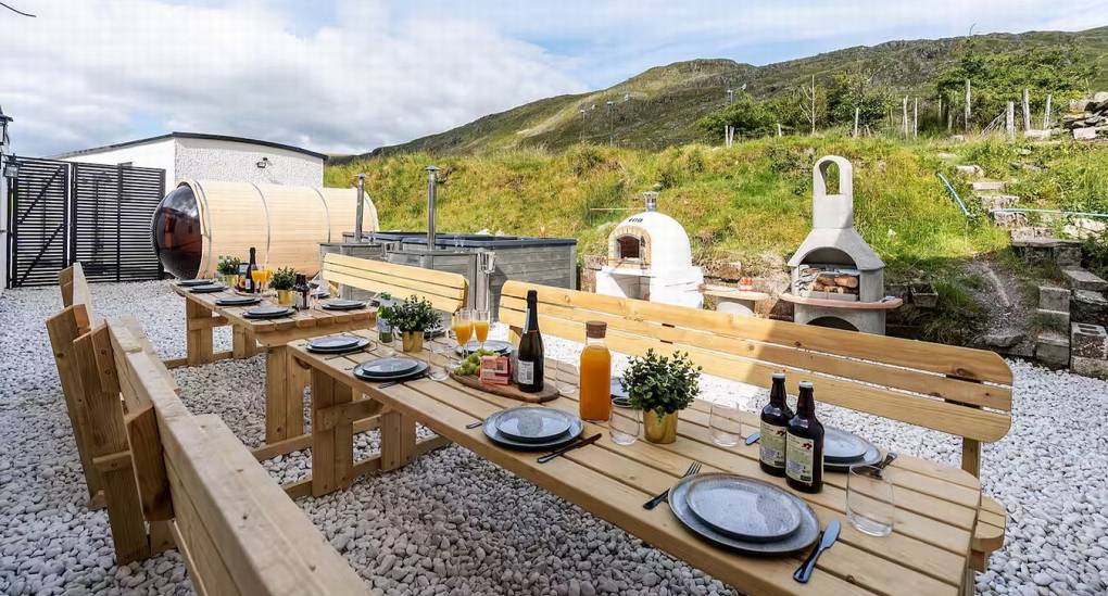 Classic outdoor wooden picnic table and seating area for al fresco dining at the Manor on the Mountain