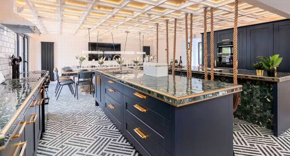 Large, fully-equipped kitchen area with the open-plan dining room visible in the background at the Manor on the Mountain