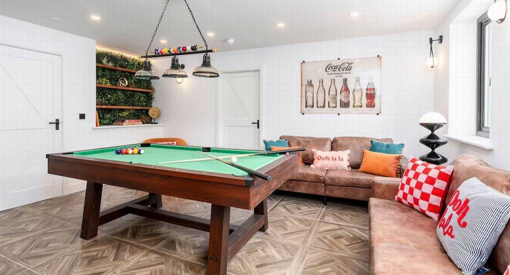 View of the pool table area and seating inside the Lake District luxury party house games room