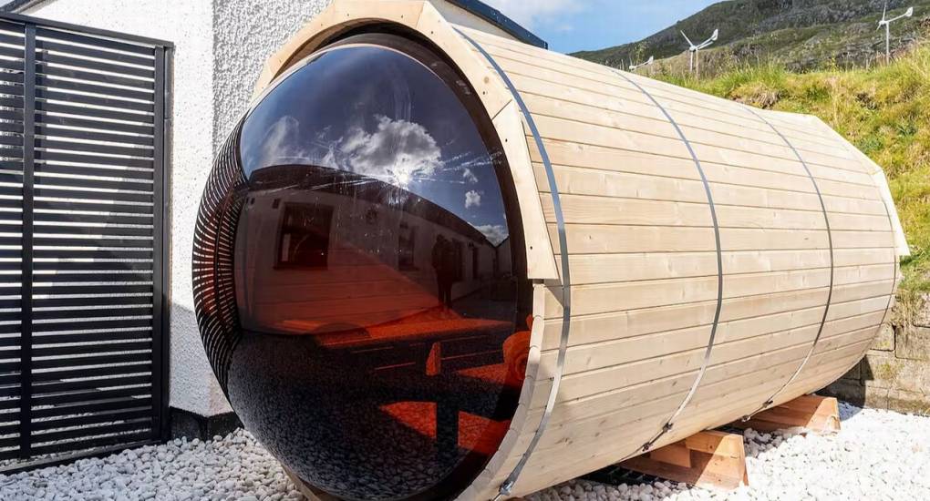 Exterior view of the wooden barrel sauna at the Manor on the Mountain luxury hen party house