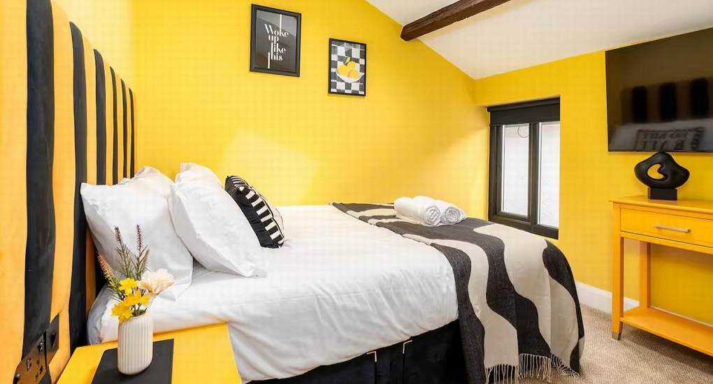 Spacious twin bedroom with bold decor and artwork at the Mountaintop Marvel party house