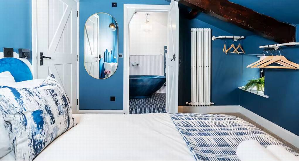 Double bedroom 1 looking through to the modern en-suite bathroom at the Lake District party house