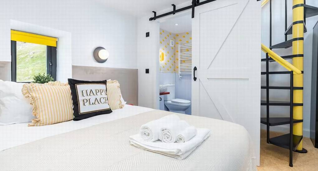 Double bed setup with distinctive lighting and features in bedroom 7 at Mountaintop Marvel