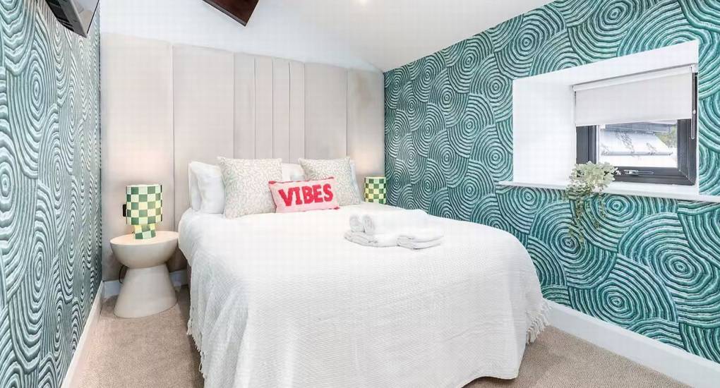 Comfortable double bedroom with bold, unique colour scheme for guests at the Lake District retreat