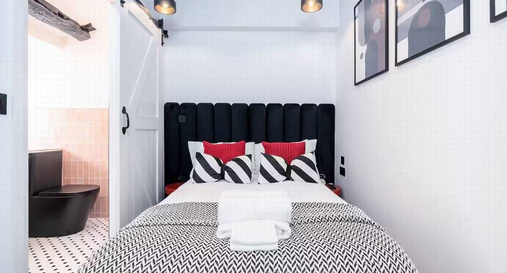 Stylish double bedroom with decorative neon light feature at the Mountaintop Marvel accommodation