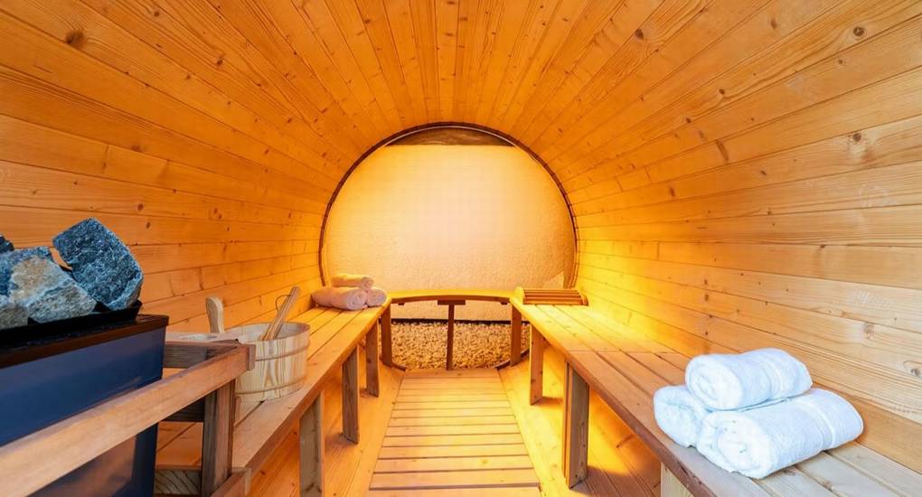 Interior view of the spacious wooden sauna for relaxation at the Mountaintop Marvel party house