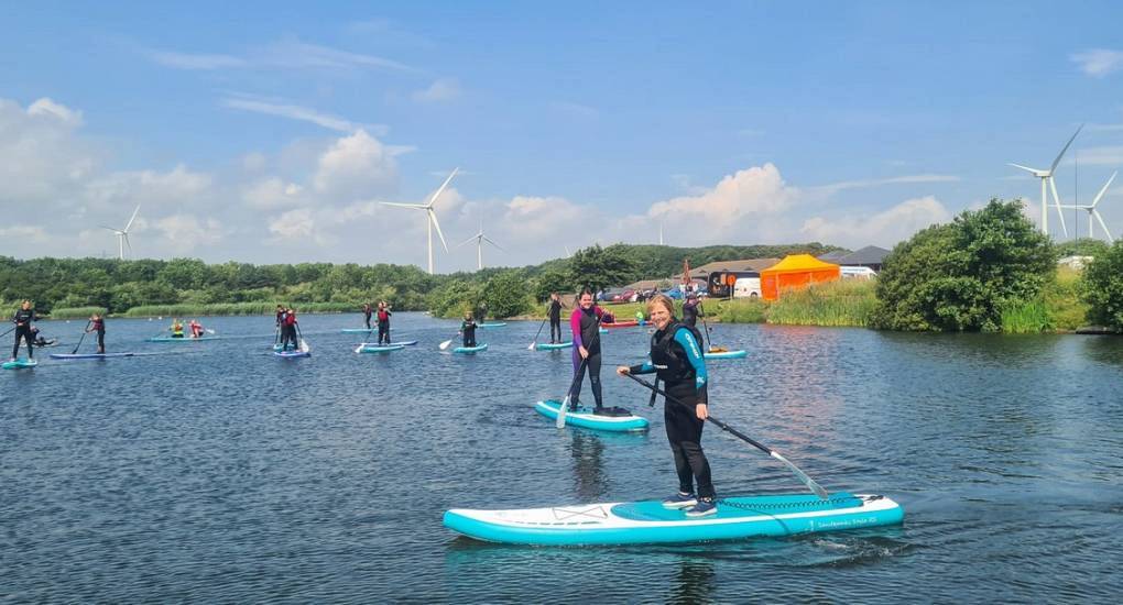 Hen party paddle boarding on a river