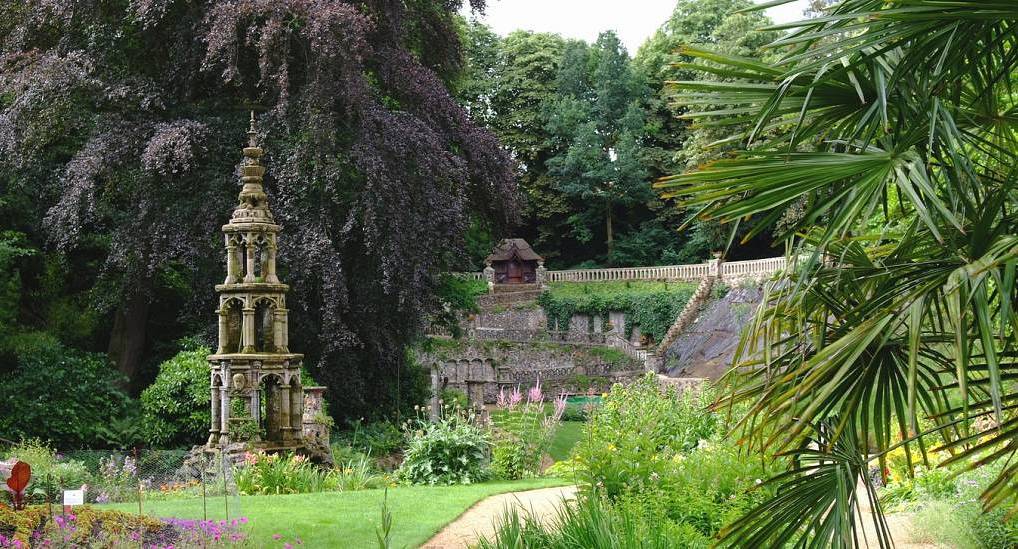Gothic stone fountain and sunken terraces at The Plantation Garden, scenic outdoor spot for a Norwich hen do.