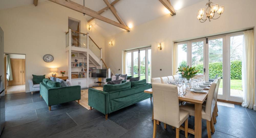 The vaulted open plan lounge and dining space at Nutley Barn, a Norwich hen party barn with a hot tub.