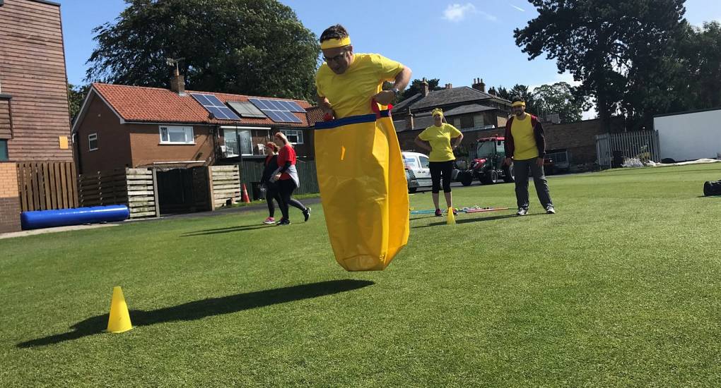 Stag taking on the sack race event in the Old School Sports Day activity