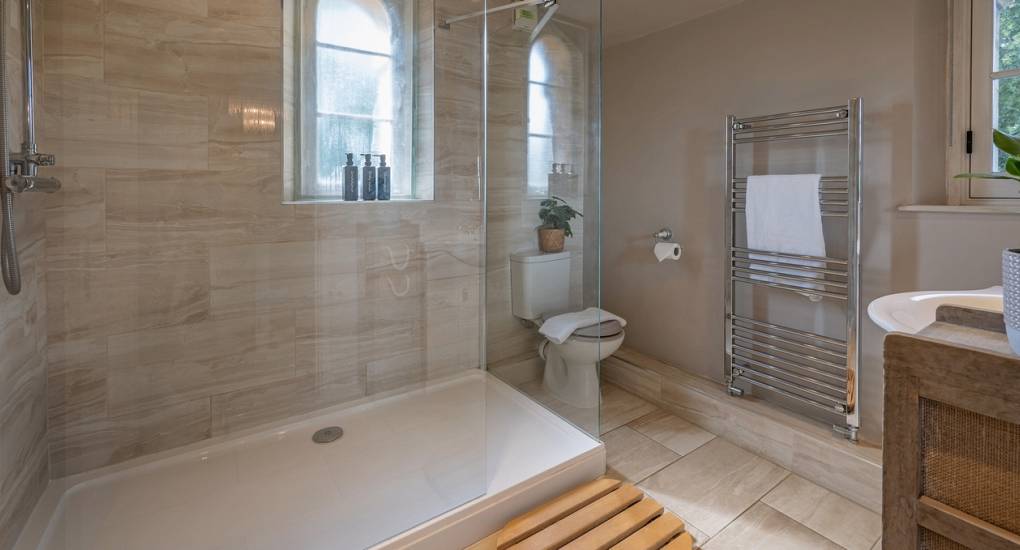Modern walk-in rainfall shower at Summerset House: Luxury Bath hen do accommodation with 5 bathrooms for large group prep.