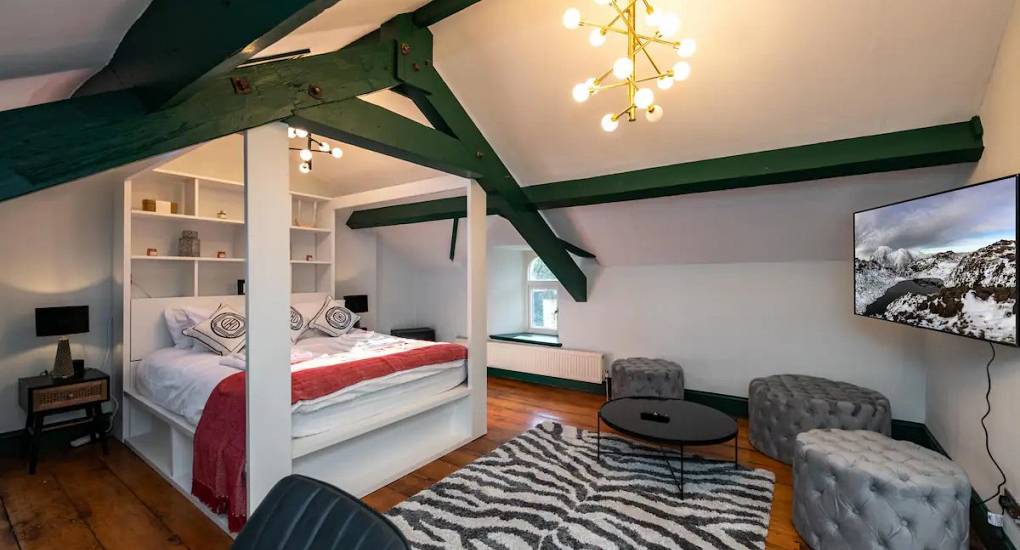 Spacious bedroom with a double bed made up