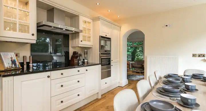 View of the white kitchen area with glimpse of dining table