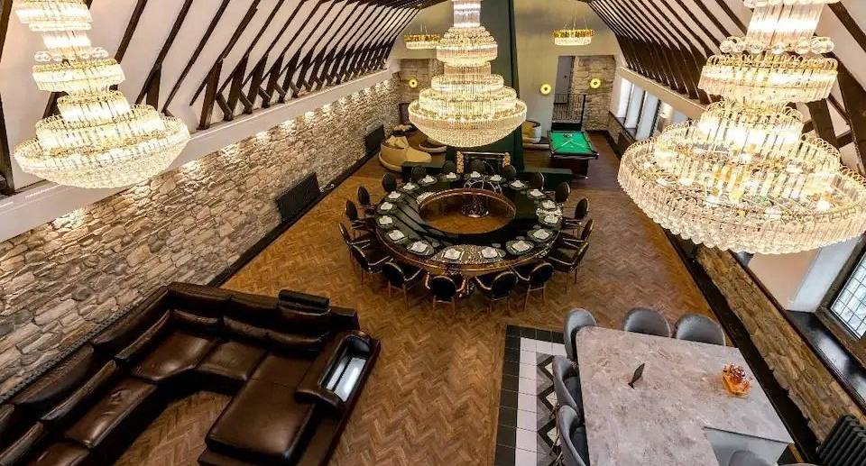 Overhead pic showing the open plan living space includes pool table, dining table, bar area and corner sofa