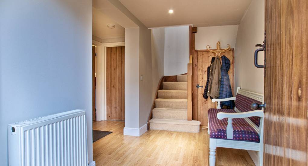 Hallway with seating and stairs 