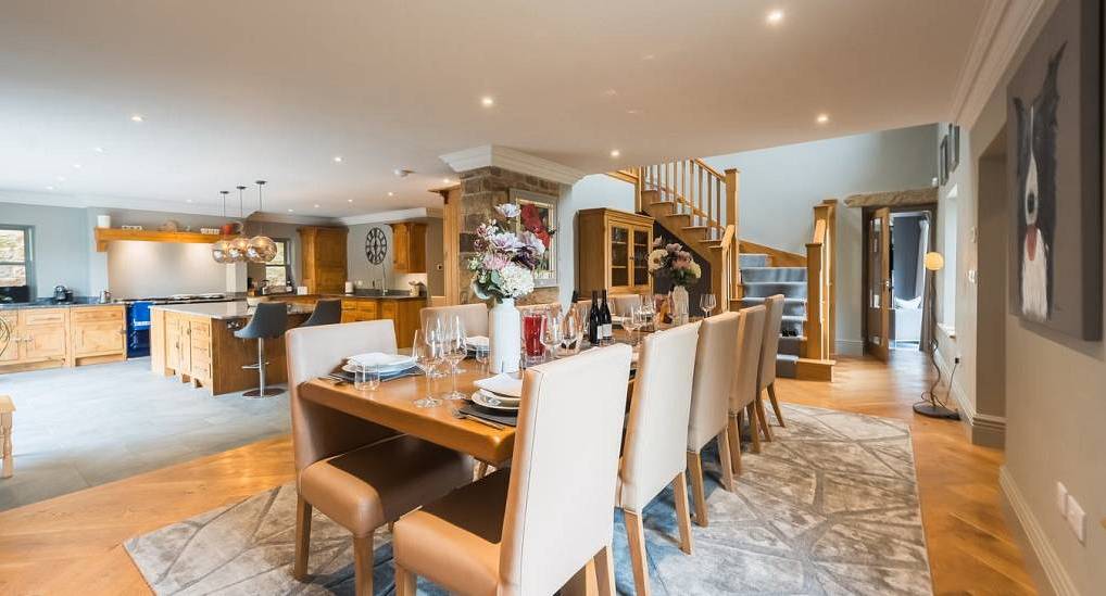 Idyllic Cottages: Modern open-plan kitchen and dining area for a 14-person hen party stay in the Peak District.