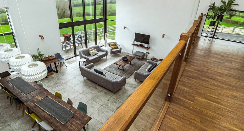 Tree View: Open-plan lounge and mezzanine games room inside a luxury 7-bedroom converted hen barn.