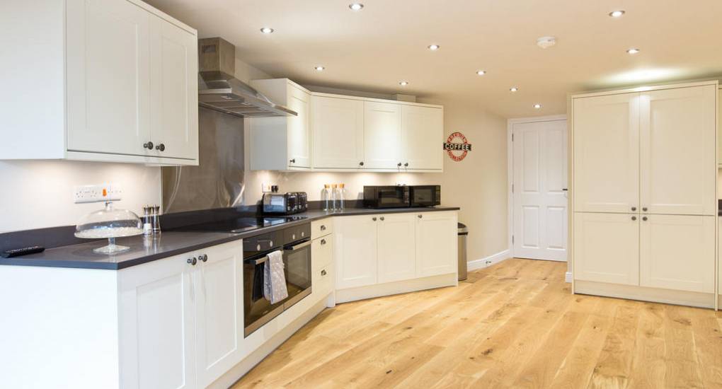 Alternative view of the modern kitchen at Peak Star house featuring high-end appliances for self-catering hen parties.