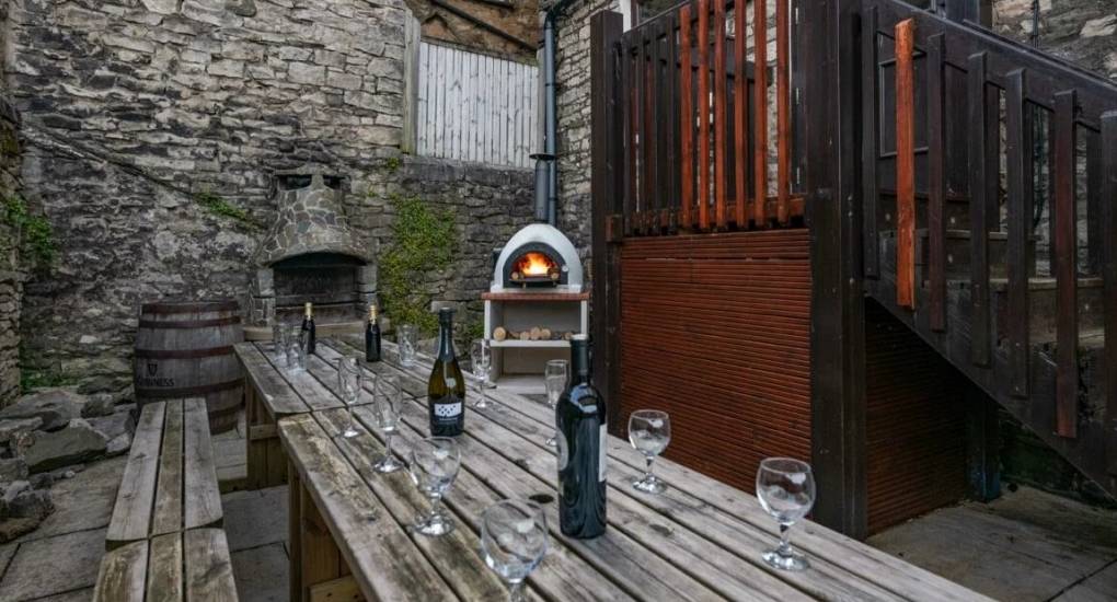 More pub style benches outside with bbq and firepit in the background
