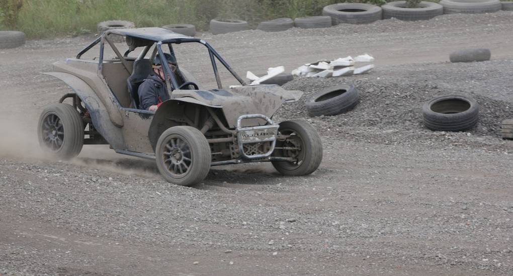 Rage buggy coming out of the corner on a dirt track