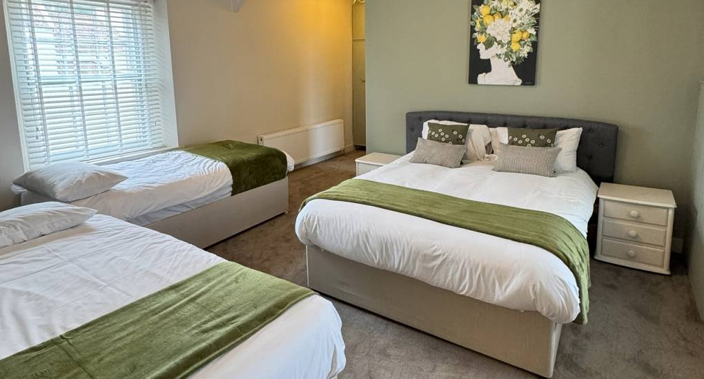 Regal Manor two luxury party house bedroom with three single beds made up