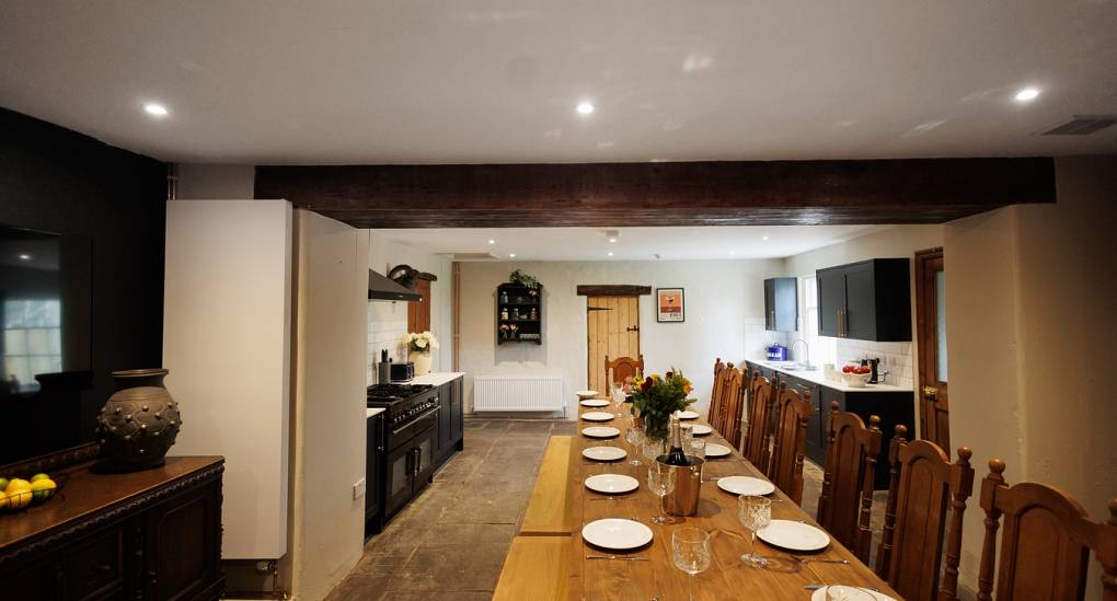 Another view of the large dining table at the Regal Manor two luxury party house