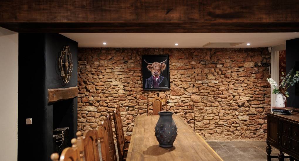 View along the long rustic dining table at the Regal Manor two luxury party house