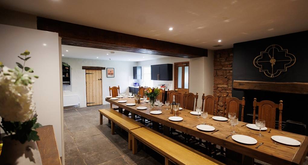 Impressive view of the dining room with long dining table at the Regal Manor two luxury party house