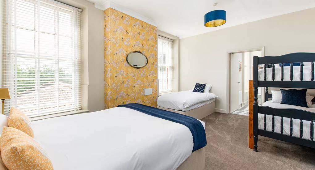 Bedroom with one single and double with bunkbeds at the Regal Manor two luxury party house