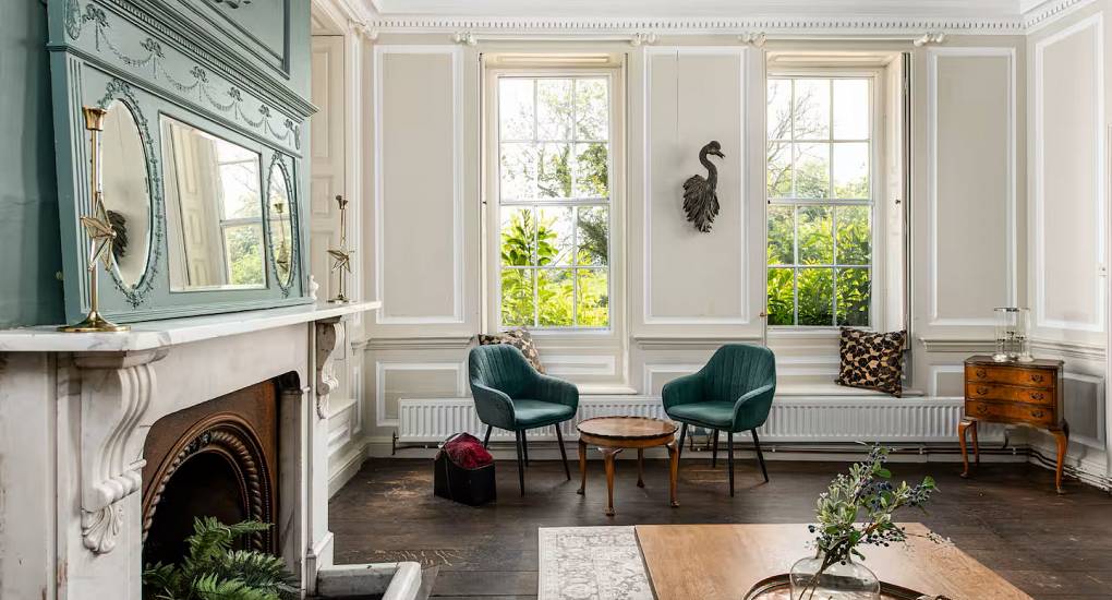 Large windows and fire place in the lounge at the Regal Manor two luxury party house