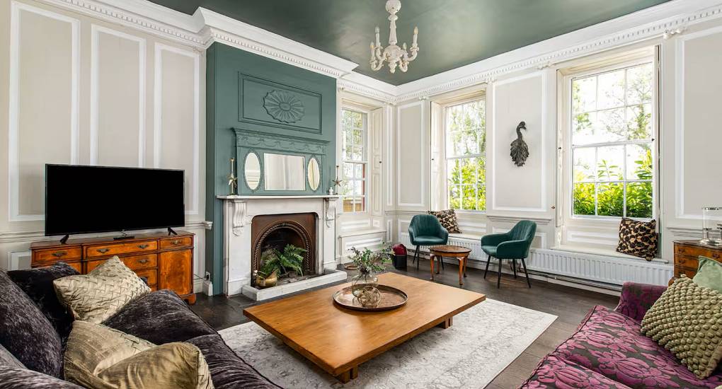 Large windows letting in light in the lounge at the Regal Manor two luxury party house