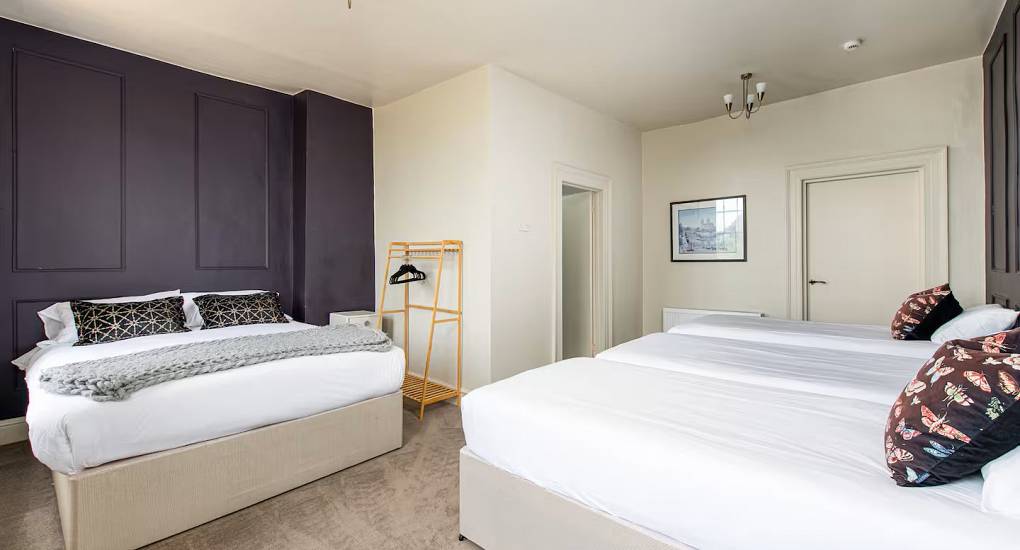 Two king size beds in bedroom at the Regal Manor two luxury party house