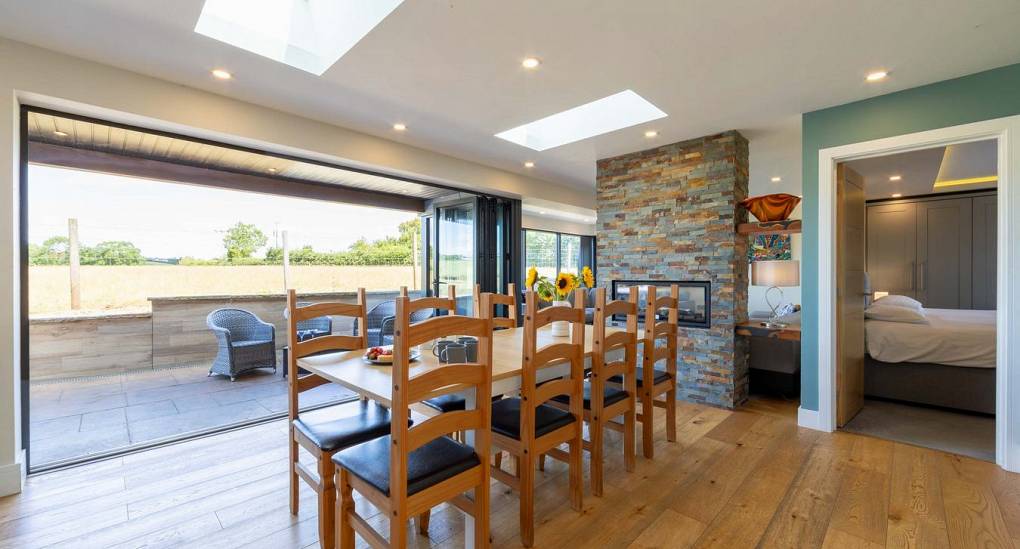 Open plan dining area in front of bi-fold doors at Retreat 12