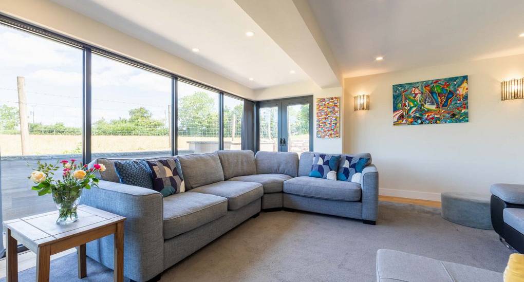Retreat 12 offering the perfect chillout area with this corner sofa in front of the glass wall. 