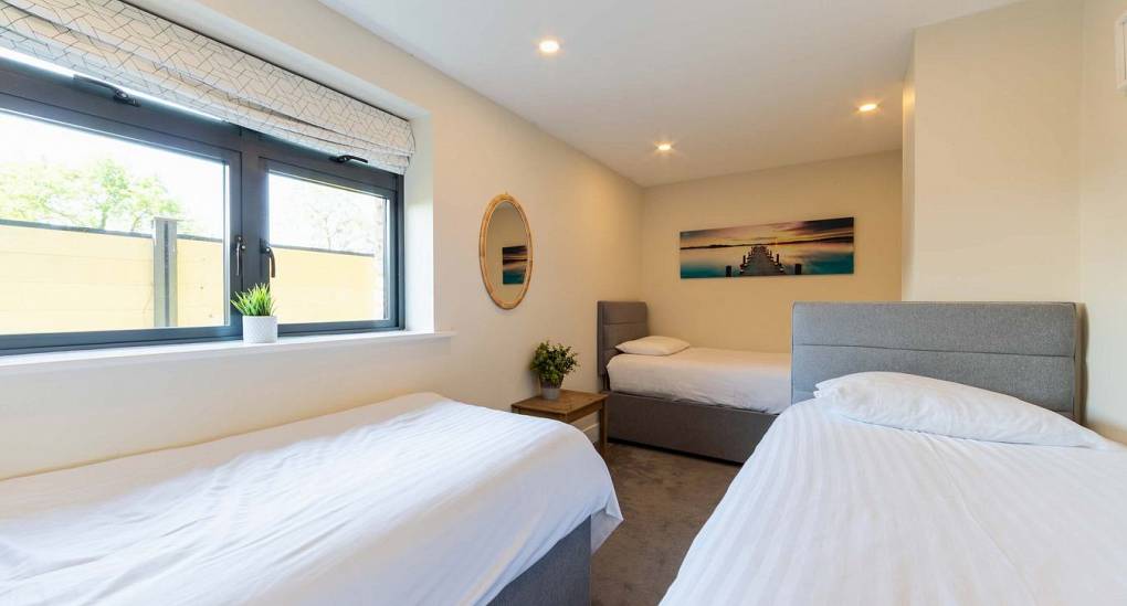 This is one of the smaller bedrooms at Retreat 12, sleeping 3 people in 3 singles