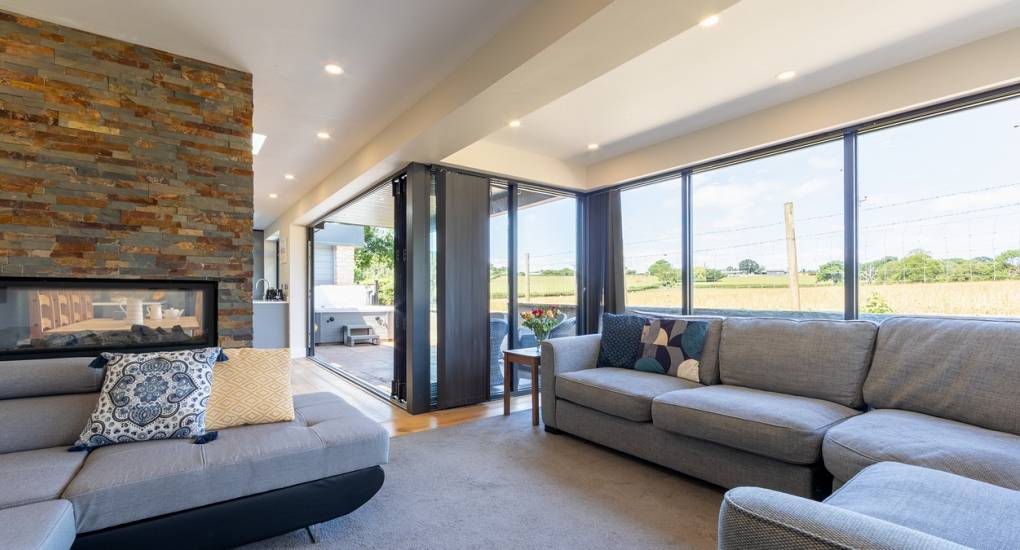 Stunning lounge area with feature chimney breast at the Retreat 12 Bristol Party House
