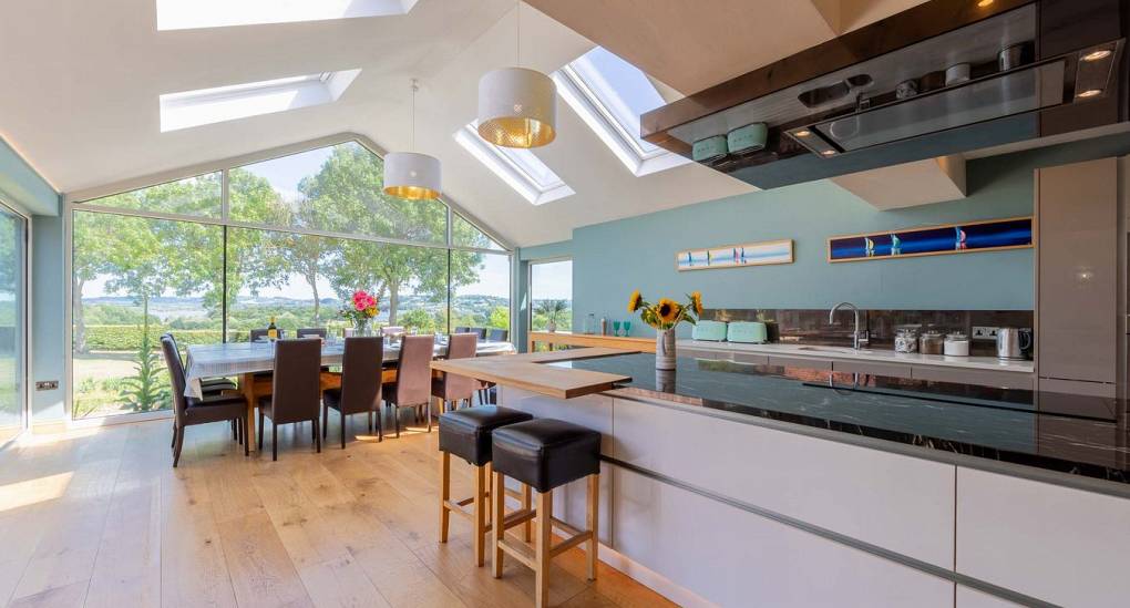 The kitchen, dining room view with skylights and glass wall.