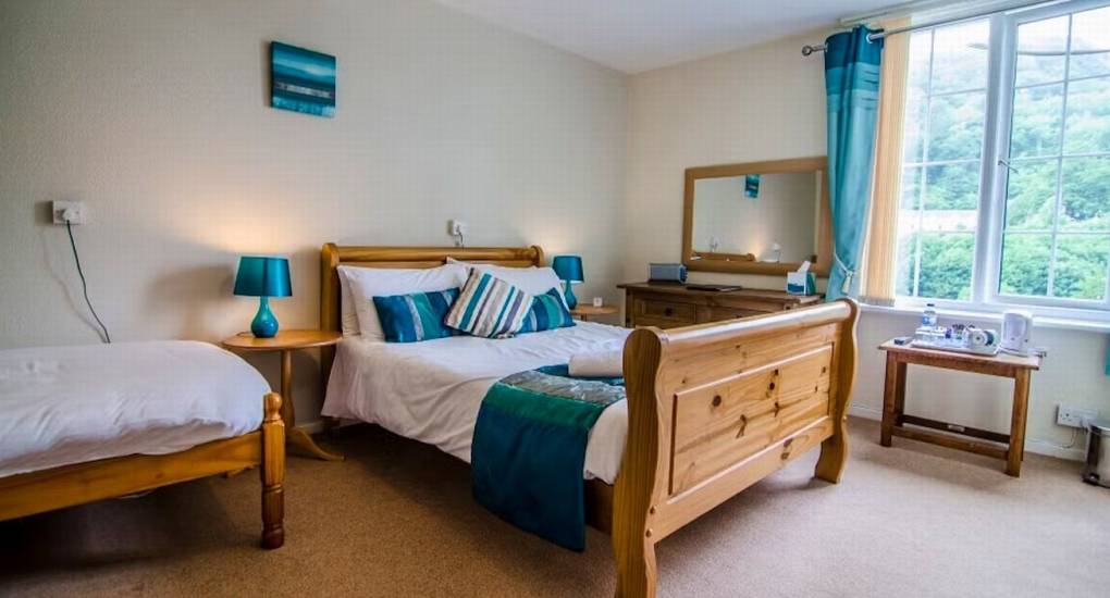A multi-bed room at River View Lodge with a double and single bed, providing flexible sleeping arrangements for your hen group.