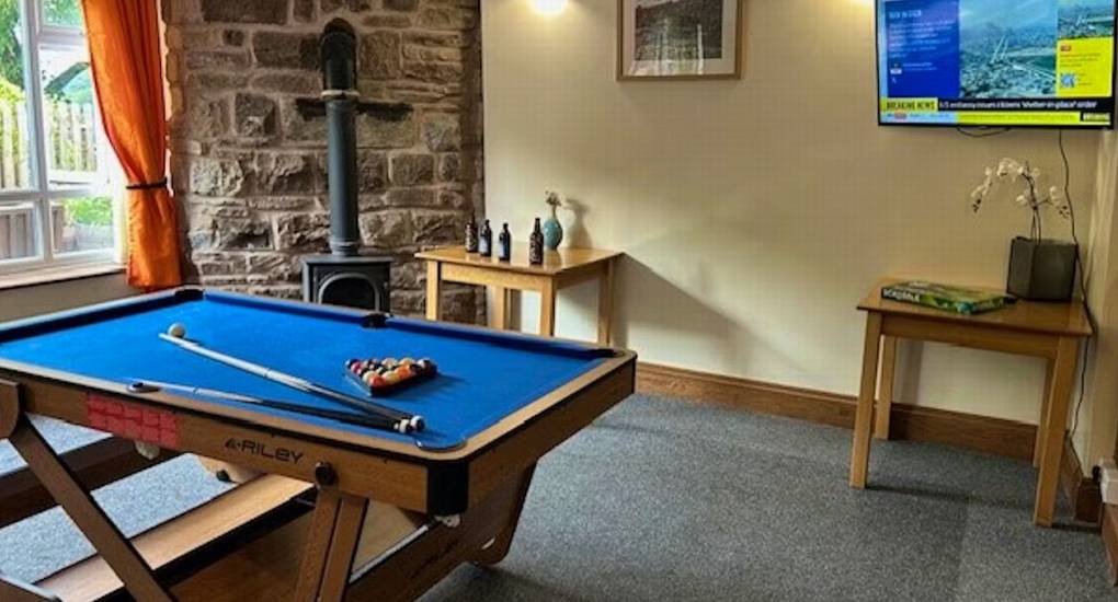 The games room at this Herefordshire hen party house, featuring a large pool table for friendly competitions.